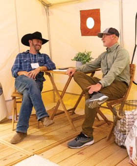 Two men discuss the glamping industry inside a glamping yurt at the Glamping Show Americas.